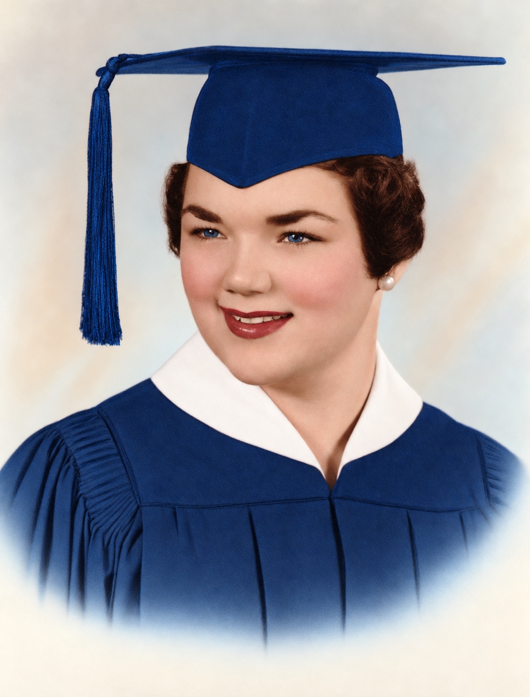 Judy in a blue graduation gown.